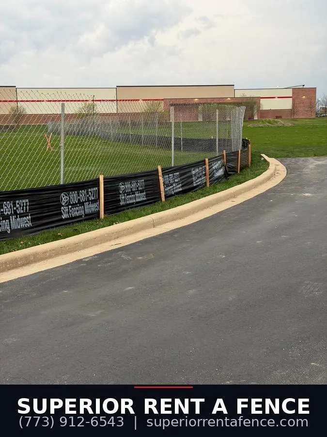 Six-foot chain link construction fence with silt fence along a commercial perimeter